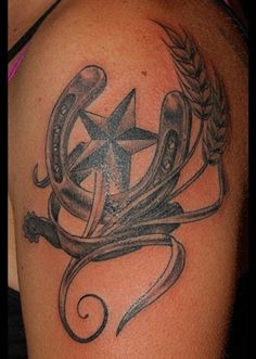 a black and grey tattoo with an anchor, star and wreath on the shoulder for men