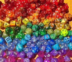 many different colored dices on a wooden table with numbers in the middle and one number missing