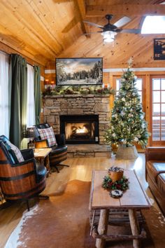 a living room filled with furniture and a christmas tree in front of a fire place