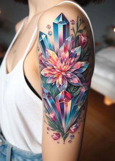 a woman's arm with an artistic tattoo design on it and a flower in the center