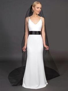 a woman wearing a white and black wedding dress