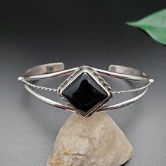 Black Sterling Silver Bangle, Black Sterling Silver Bangle Bracelet, Elegant Adjustable Black Sterling Silver Bracelet, Modern Black Sterling Silver Bracelet, Elegant Black Sterling Silver Bangle, Black Sterling Silver Bangle Bracelets, Adjustable Black Sterling Silver Cuff Bracelet, Elegant Black Sterling Silver Bracelet With Polished Finish, Classic Black Cuff Bracelet In Bangle Style