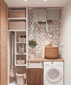 a washer and dryer in a small room next to a wall mounted shelf