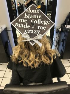 a woman sitting in a chair wearing a graduation cap that says don't blane me college made me crazy