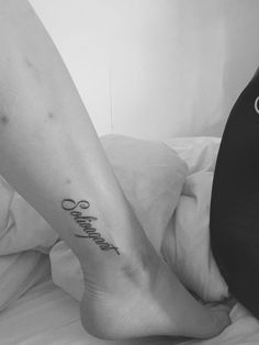 a woman's foot with a tattoo that reads, love and happiness on it