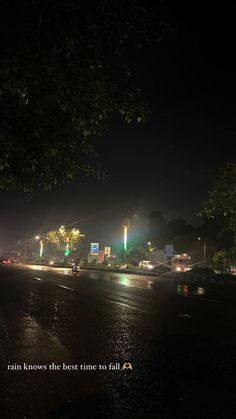 an empty street at night with the lights on