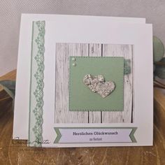 a close up of a greeting card with a heart on the front and green border