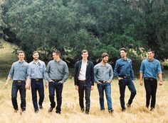 a group of men standing next to each other in a field