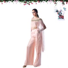 Embrace effortless elegance with this stunning indo-western dress for women. Designed with a modern touch, this ensemble features a chic crop top adorned with delicate floral detailing and dramatic fringes, paired with high-waisted palazzo pants. Ideal for those looking for unique indian pant suits for ladies, it combines comfort and glamour in one statement outfit. Perfect for weddings, sangeet, or any festive occasion, this outfit blends traditional Indian wear with western sophistication, mak Indian Pant Suit, Pant Suit For Women, Indian Party Wear Dresses, Indian Pants, Indo Western Dresses For Women, High Waisted Palazzo Pants, Fusion Wear, Pant Suits For Women, Statement Outfit