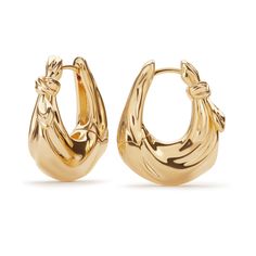 The Hera Gold Hoop Earrings symbolize the strength and grace found in moments of upheaval. Their bold design and golden tones make them a statement piece that reflects the wearer's resilience and elegance. When not wearing your jewellery:  Store pieces individually in their pouch or box to avoid rubbing, scratching, and tangling.   Store them in a cool, dry and dark place, such as a drawer or jewellery box.   Silver jewellery should be stored in an airtight plastic bag or box to reduce oxidation.   When wearing your jewellery:  Avoid your jewellery encountering beauty products and lotions like perfume, hairspray, make up, sunscreen, deodorant, and skin oils.   Wear silver jewellery often to slow down oxidation. Luxury Brass Hoop Earrings As Gift, Luxury Plated Brass Earrings, Luxury Pierced Brass Hoop Earrings, Luxury Gold Brass Hoop Earrings, Luxury Tarnish-resistant Brass Hoop Earrings, Golden Earrings, August Birthstone Jewelry, July Birthstone Jewelry, Men's Jewelry Rings