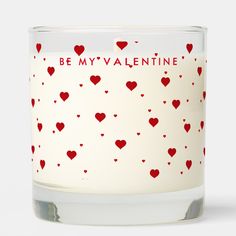 a candle that has hearts on it with the words be my valentine written in red