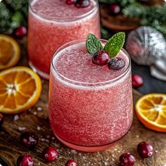 two glasses filled with cranberry punch on top of a wooden table