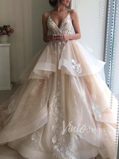 a woman standing in front of a mirror wearing a wedding dress