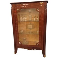 an antique display cabinet with glass shelves