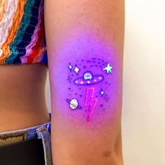 a woman's arm with a tattoo on it that has an image of the planets and stars