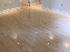 an empty room with hard wood floors and white walls