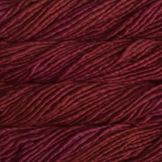 skeins of yarn in shades of purple and red