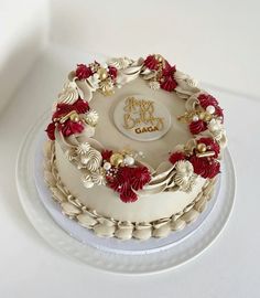 a white cake with red and gold decorations