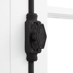 a black door handle on a white door