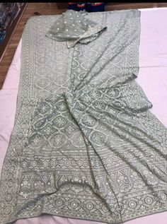 Update! - Zynah covered by LBB - https://lbb.in/bangalore/zynah-designs-handloom-sarees/ Pure Georgette Saree with intricate thread chikankari work. Beautiful motifs like flowers and diamonds are made using different kind of stitches. Sequence handwork is done through out the saree as a highlighter to enhance the beauty of saree. Dyeable to any shade as per your choice and contrast color blouse piece can be provided on demand Length: 5.5 meters Width: 1.2 meters Blouse: Running/attached with sar Pista Green Chikankari Embroidered Fabric For Wedding, Silver Traditional Wear With Chikankari Embroidery, Silver Traditional Wear With Chikankari Embroidery For Weddings, Pista Green Dupatta With Chikankari Embroidery For Reception, Unstitched Suit With Chikankari Embroidery For Reception And Festivals, Pista Green Chikankari Embroidery Lehenga In Georgette, Festive Multicolor Chikankari Embroidery Saree, Pista Green Lehenga With Chikankari Embroidery, Pista Green Chikankari Lehenga In Georgette