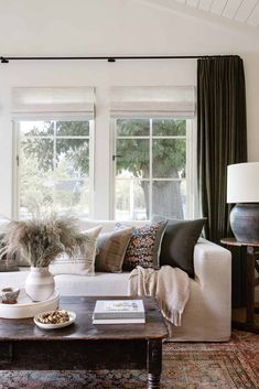 a living room filled with furniture and windows