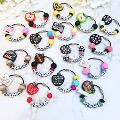 a bunch of different types of bracelets on a marble surface with flowers in the background