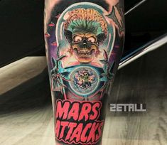 a man with a tattoo on his leg that says mars attacks and an image of a skull