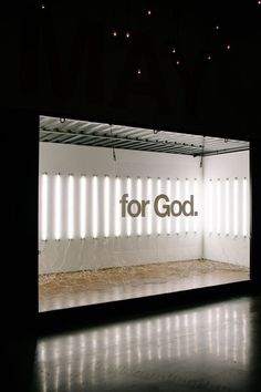 an empty room with the words for god projected on it