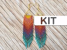 a pair of colorful beaded earrings with the word kit on it