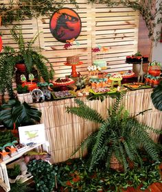 an assortment of plants and desserts on display in a room with wood paneling