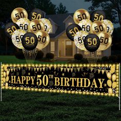 happy 50th birthday banner with balloons in front of a house