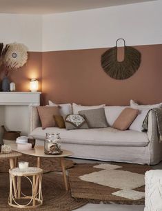 a living room with couches, tables and lamps on the wall in front of a fireplace