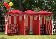 two red and white striped tents with balloons