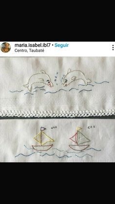 two embroidered napkins with dolphins and sailboats on them