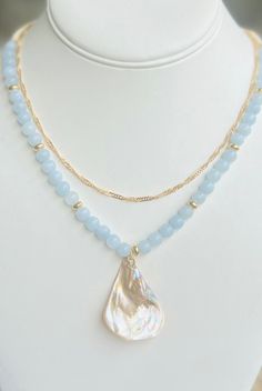 Get summer ready with this beautiful boho necklace! Made with Genuine Aquamarine gemstones in beautiful blue hues and accented with small shell beads, gold beads, and gorgeous Abalone Shell Pendant. Also comes with a beautiful gold layering necklace for an extra styled look as a gift. This piece is customizable and beautifully made, a perfect gift Mother's Day, birthdays, showers, Anniversary gifts, best friend gifts and anytime wear.  Please choose your custom size at check out!  Each piece comes in an elegant drawstring gift bag as shown and a free gold necklace!  Please contact me with any questions.  Shipping Every item is carefully wrapped for shipment and includes a small keepsake adjustable woven bag. Shipping is fast and sent out the next day via usps first class mail. Message me w Necklace Shell, Stone Beaded Necklace, Aquamarine Jewelry, Friend Gifts, Shell Necklace, Boho Gifts, Gold Necklace Layered, Shell Jewelry, Aquamarine Gemstone