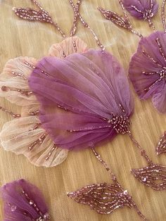 purple flowers and beads on a table cloth