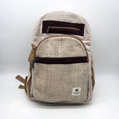 Introducing our handmade hemp backpack, a durable and eco-friendly option for carrying all your essentials. Crafted by skilled artisans, this backpack is made from high-quality hemp fiber and Heavy Duty Gheri Cotton fabric, known for its strength and durability. Not only is this backpack sturdy, but it also features a spacious interior with plenty of room for your laptop, books, and other daily necessities. The adjustable straps provide a comfortable fit, and the reinforced stitching ensures the backpack can withstand heavy use. But that's not all – our hemp backpack is also environmentally friendly. Hemp is a sustainable crop that requires minimal water and no pesticides, making it a popular choice for eco-conscious consumers. Plus, the backpack is handmade, so you can feel good knowing t Casual Hemp Bags For Daily Use, Eco-friendly Travel Backpack, Eco-friendly Backpack For Everyday Use, Eco-friendly Everyday Backpack In Natural Color, Eco-friendly Brown Backpack For Travel, Eco-friendly Handmade Backpack, Eco-friendly Brown Travel Backpack, Casual Natural Color Standard Backpack, Eco-friendly Brown Backpack For Everyday