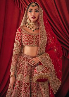 Bridal Lehnga Choli with Golden Embroidery with beautiful embroidery, dabka and sequins. This lehnga is unique in style and have classy look and perfect choice for traditional bride. Choli: Short Choli for bridal dress in red color is embellished with embroidery, antique dabka, nakshi, stones, kamdani work. Neckline is décor with embroidery and without sleeves. Fabric used for choli is raw silk. Lehnga: Stylish lehnga in red color is embellished with sequins, dabka, crystals, stones, cutdana wor Lehenga Choli Pakistani, Nameera By Farooq, Pakistani Bridal Dresses Online, Lehenga Choli Latest, Pakistani Lehenga, Bridal Mehndi Dresses, Red Lehenga Choli, Pakistani Bridal Dress, Golden Embroidery