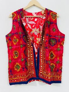 Fulkari open vest is made from a soft traditional indian phulkari handmade scarf. the scarves are used for festive occasions like weddings. the phulkari scarf is hand embroidered and embellished by indian artisan. vest has long wide vest coat. the vest jacket has an open front, and the length is normal jacket. indian chanderi silk phulkari hand work boho fashion kimono robe jacket. indian embroidered boho style beach wear body cover up. reversible vest jackets/coat you can wear this one in both side one side is phulkari embroidered and other side is cotton printed. *buy it for the holidays! looks fabulous over a long silk tank dress or palazzo pants. or wear it with to install jeans and boots. measurements: colour: as per the picture approx length : 23 inch / 60 cm bust approx : 40 inch / Bohemian Red Choli For Puja, Traditional Nehru Jacket With Dupatta For Festivals, Festive Sleeveless Handwork Choli, Festive Nehru Jacket With Motifs, Traditional Sleeveless Wear For Festivals, Traditional Nehru Jacket With Dupatta For Festive Occasions, Bohemian Choli With Pallu For Festivals, Red Bohemian Choli For Traditional Ceremonies, Red Bohemian Choli For Navratri