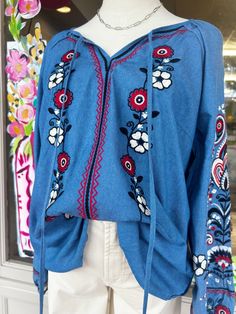 Our Oehler Denim top is one of my favorites for Fall. Pair with white or black denim for a classy Fall outfit Features gorgeous red, white, and black floral embroidery detail Features tassel tie detail Features elastic band detail on the sleeves 100% polyester Model is a size 4/6 wearing a size small and 5'6 Casual Blue Tops With Tassel Ties, Casual Blue Tops With Tie Sleeves, Long Sleeve Cotton Top With Tassel Ties, Long Sleeve Cotton Tops With Tassel Ties, Fall Cotton Tops With Tassels, Cotton Long Sleeve Tops With Tassel Ties, Cotton Tops With Tassels For Fall, Casual Long Sleeve Tops With Tassel Ties, Casual Embroidered Denim Blouse