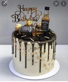 a birthday cake with chocolate icing and gold decorations