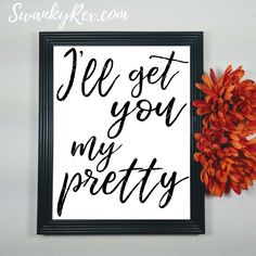 a black and white sign that says i'll get you my prettyy next to an orange flower