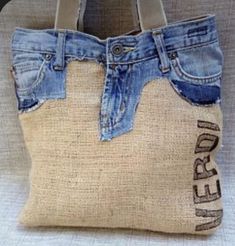 a handbag made out of old jeans with the word denim on it's side