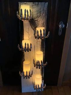 several candles are lit in front of a door