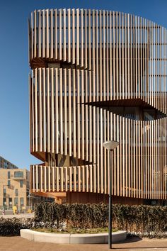 the building is made out of wood and has many vertical slats on it's sides