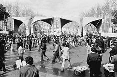 a crowd of people walking across a street