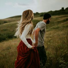 a man standing next to a woman in a field