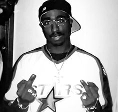 a black and white photo of a man with a star on his shirt