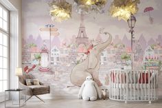 a baby's room with an elephant mural on the wall