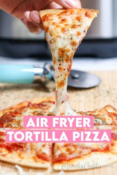 a person taking a slice of pizza from a pan with the words air fryer tortilla pizza on it